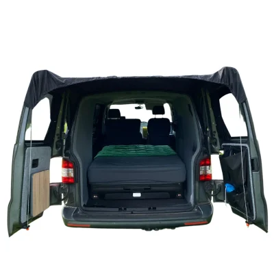 Rear view of a grey VW Transporter with the OLPRO barn door canopy installed, showing the rigid structure and lack of guy lines.